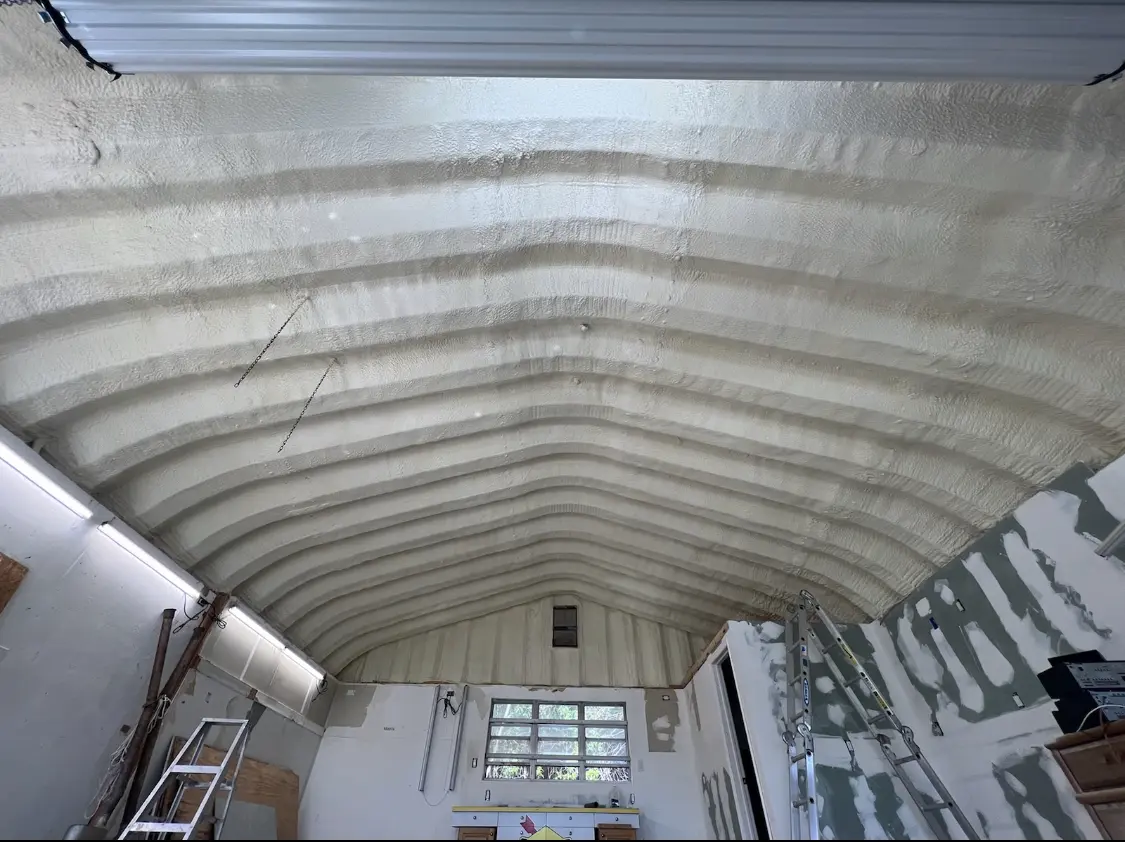 Spray polyurethane foam applied to the underside of a metal roof deck in Griffin